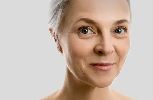 Mature woman using skincare products